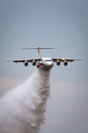 Avalon, Australia - February 27, 2015: Coulson Aviation BAE Systems 146 (Avro RJ85) aerial fire fighting aircraft N355AC dropping a large load of water.のeditorial素材
