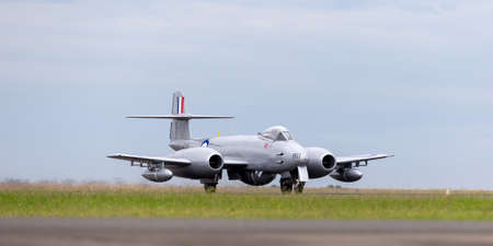Avalon, Australia - February 28, 2015: Gloster Meteor F.8 aircraft VH-MBX in Korean War era Royal Australian Air Force (RAAF) markings taxiing down the runway at Avalon airport.のeditorial素材
