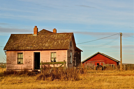 Abandoned farm house and red barn の写真素材