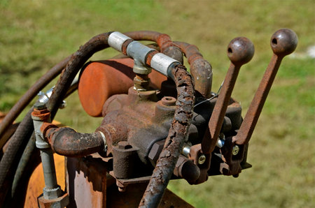 Old levers on a hydraulic pumpの写真素材