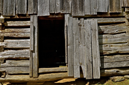Open shed or barn door of old weathered graying woodの写真素材