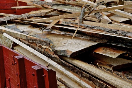 A truck with a wooden and painted box is full of scrap lumber from a sawmillの写真素材
