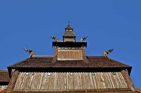 The carvings, of dragon heads appear on the top of a Norwegian stave churchの写真素材