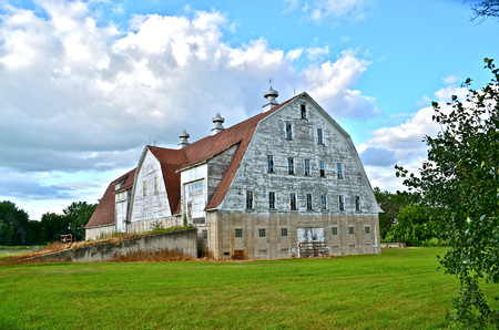 Large majestic white barn with many windows and cupolasの写真素材