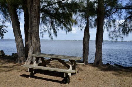 Picnic table along ocean shorelineの写真素材
