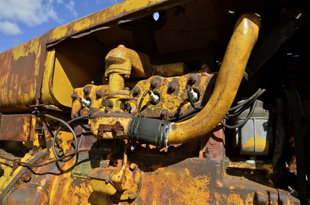 Old yellow tractor engine with spark plugsの写真素材