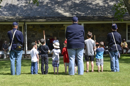 FORT SISSETON, SOUTH DAKOTA - June 6, 2015:  7th Cavalry offiecers reenact the process of of military training to volunteer youngsters at the annual Fort Sisseton Historical Rendezvous held annually the first full weekend of June.のeditorial素材