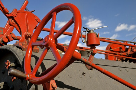 Brightly red painted steering wheel of a steam engineの写真素材