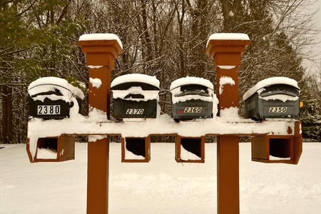 Mailboxes covered with fresh layer of snow after a storm.