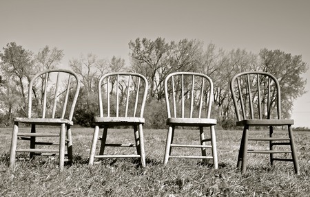 Old Windsor chairs  lined up in a rowblack and whiteの写真素材