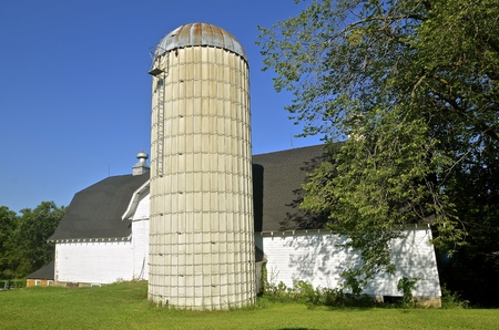 Barn and silo of an old dairy farm is kept well groomed.の写真素材