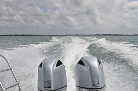 Huge twin engine outboard boat motors leave a huge wake  in the Caribbean Sea