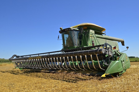 MAYVILLE, NORTH DAKOTA-August 19, 2015: A self propelled combine in a wheat harvest scene is a...