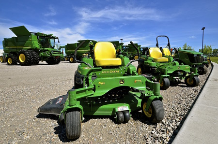 MOORHEAD, MINNESOTA, June 6, 2016: The new combines and riding lawn mowers are products of John Deere Co, an American corporation that manufactures agricultural, construction, forestry machinery, diesel engines, and drivetrains.のeditorial素材