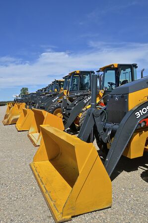 MOORHEAD, MINNESOTA, June 6, 2016: The new backhoe and front end excavator machines  are products of John Deere Co, an American corporation that manufactures agricultural, construction, forestry machinery, diesel engines, and drivetrains.のeditorial素材