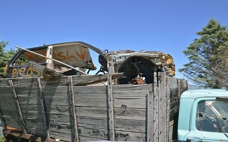 Save Download Preview Old truck with wooden box loaded with a wrecked car ready to be crunched.の写真素材