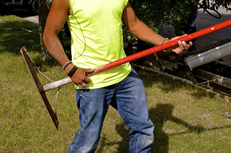 Construction worker uses concrete tool to imitate a guitar player