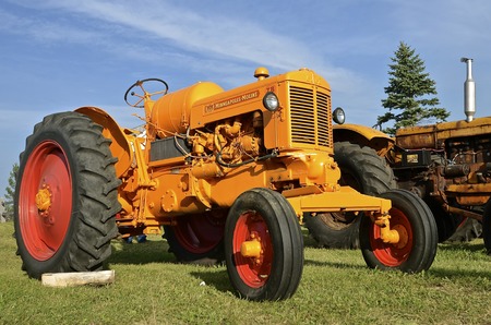 ROLLAG, MINNESOTA, Sept 1, 2016: An Minneapolis Moline ZB tractor is parked by hay racks of wheat bundles at the West Central Steam Threshers Reunion(WCSTR) where 1000s attend each Labor Day weekend in Rollag, MN each year.のeditorial素材