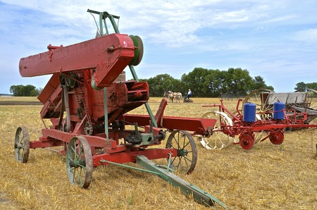 Old harvest equipment and methods demonstrated at a farm threshers showの写真素材