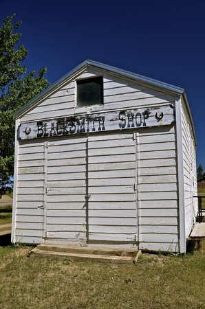 An old white sided building was once a blacksmith shopの写真素材