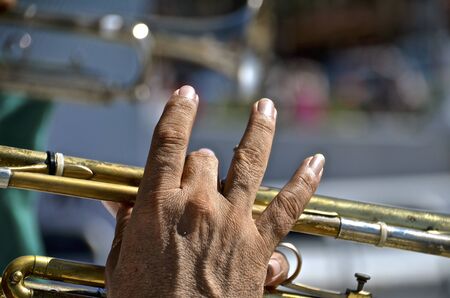Closeup of the fingers of a male trumpet player in a Mexican cityの写真素材