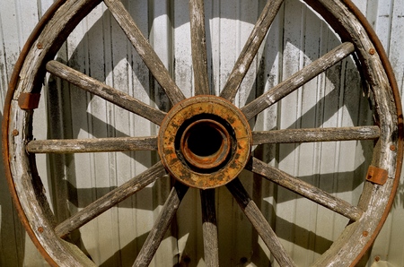 An old wooden wheel with wood spooks and hub used on a wagon or trailerの写真素材