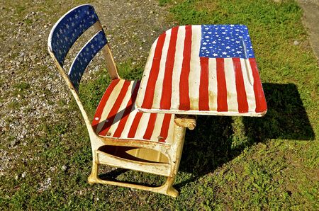 The American flag (Stars and Stripes) is painted on an old school deskの写真素材