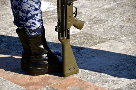 A Mexican soldier stands at attention with weapon at his side.の写真素材