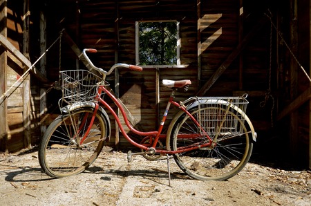 A vintage bike is parked in front of a an old shed which is being demolished,の写真素材