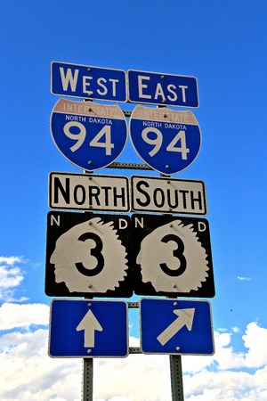 Highway road traffic signs include the I-94 Interstate and North Dakota state highway number three with an outline of an Indian Chiefの写真素材