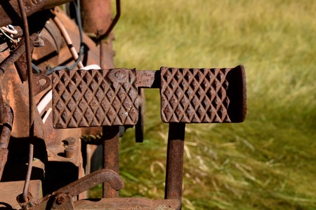 Rusty old foot brake pedals of a tractorの写真素材