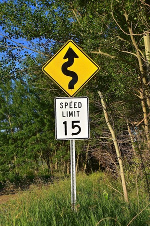Speed limit sign on a rural winding road in the countryの写真素材