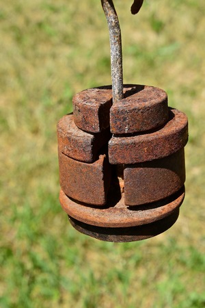 Rusty old weights for a platform mechanical floor scale for measuring grainの写真素材