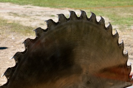 Huge saw blade for cutting dimensional lumber from logs at an outside sawmill