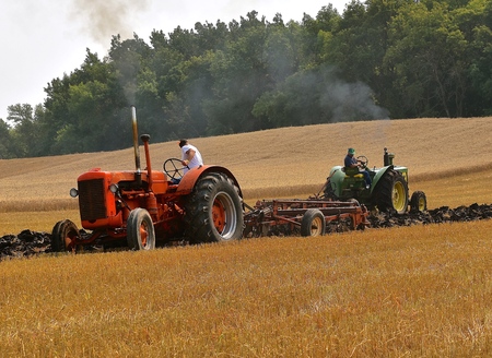 ROLLAG, MINNESOTA, Sept 2, 2017:Unidentified operators of a tractors are field demonstrating the process of plowing at the annual Dalton farm showのeditorial素材