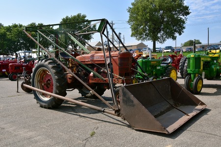 YANKTON, SOUTH DAKOTA, August 19, 2017: The  old Farmall M tractor with a homemade front end loader...