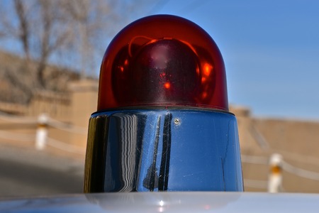 The red light on top of a 1960's police car of the 1960's.