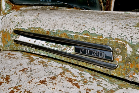 LAKE PARK, MINNESOTA, August 22, 2017; The old crusty Ford truck hood with a logo is a product of the Ford Motor Company located in Dearborn, Michigan started by Henry Ford and incorporated on June 16, 1903.のeditorial素材