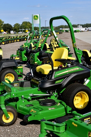 HAWLEY, MINNESOTA, August 22, 2017: A row of green and yellow new riding lawn mower tractors are products of John Deere Co, an  American corporation that manufactures agricultural, construction, forestry machinery, diesel engines, and drive trainsのeditorial素材