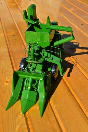 DALTON, MINNESOTA, Sept 8, 2017: A toy John Deere two row self propelled corn picker is displayed at the annual Dalton Threshing Bee farm show in Dalton held each 2nd full weekend in September where 1000`s attend.のeditorial素材