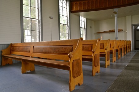 Rows of old wooden pews in a historic Lutheran churchのeditorial素材