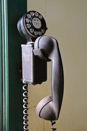 The dial and number of an outdated retro wall hanging dial phone which is no longer in existenceの写真素材