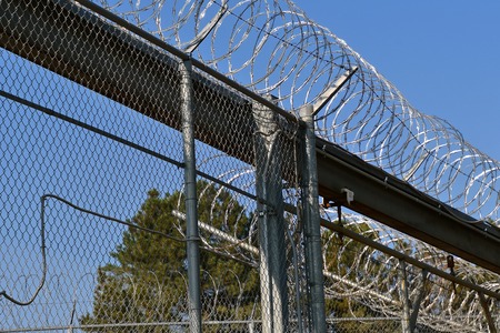 Concentina wire and chain link fence surrounding correction facilities