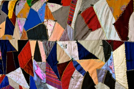 Aaa very old crazy quilt with patches of many colorsの写真素材