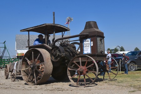 PEKIN, NORTH DAKOTA, September 2, 2018: A 1926 Oil Pull Rumely steam engine participates in a parade  during the Labor Day Stump Lake Village Threshing Bee.のeditorial素材