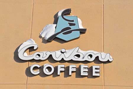 MOORHEAD, MINNESOTA, February 7, 2019: The  exterior snow covered Caribou Coffee sign is a franchise of Caribou Coffee Company,  an American coffee company and coffeehouse chain. Caribou Coffee was founded in Edina, Minnesota, in 1992.のeditorial素材