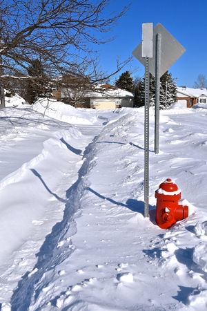 A sidewalk previously snow blown clean has partially filled in with drifting snow.の写真素材