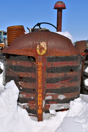 BARNESVILLE, MINNESOTA, March 11, 2019: The logo and grill on a tractor is a Massey Harris which eventually became Massey Ferguson when a merger of Massey Harris and the Ferguson Company farm machinery manufacturer occurred in 1953のeditorial素材