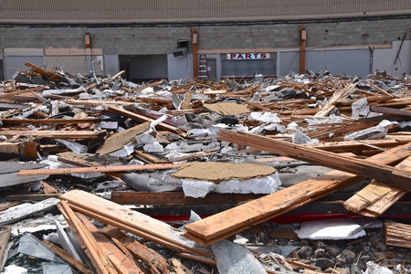 Brick, metal, and debris are left on the ground after a demolition project.の写真素材