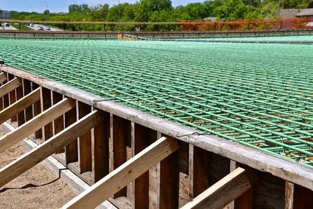 Layers of rebar in the construction of a bridge over a four lane highway which is ready for concreteの写真素材